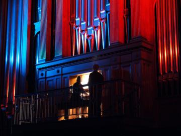colorful lights bounce off the organ pipes in Finney Chapel