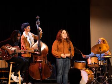 Small jazz ensemble of guitar, bass, and vocalist perform.