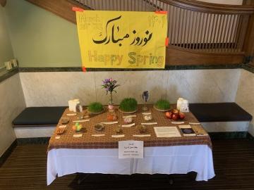 Table of seasonal offerings under a sign that says Happy Spring