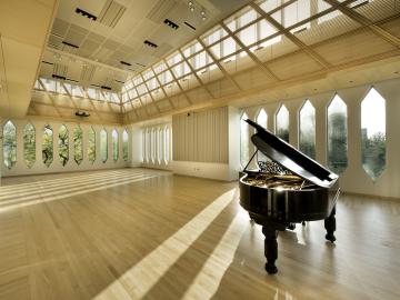 Grand piano in the sunlit David H. Stull Recital Hall