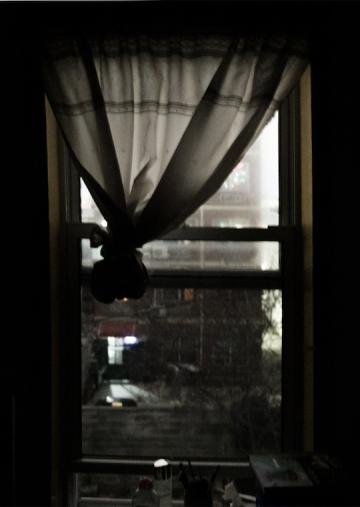 A curtain in a dark room.