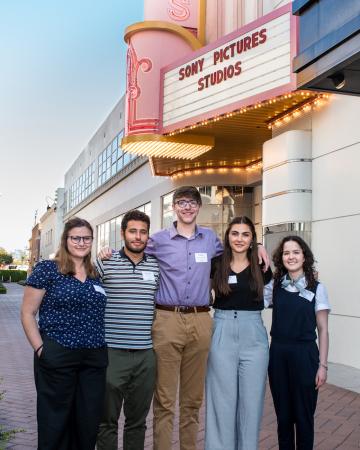Five interns pose under the Sony Pictures Studios marquee