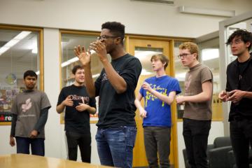 Students perform acapella in the library.