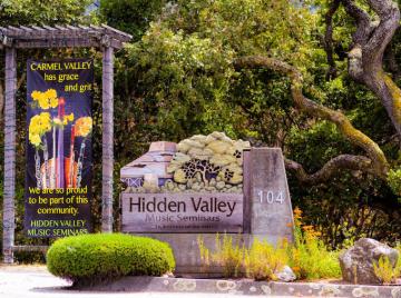 'Hidden Valley Music Seminars' sign surrounded by natural landscaping.