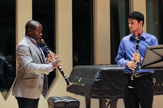 Clarinetist Anthony McGill playing as student observes