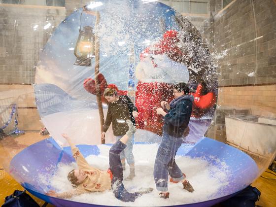 Students play in an inflatable snow ball.
