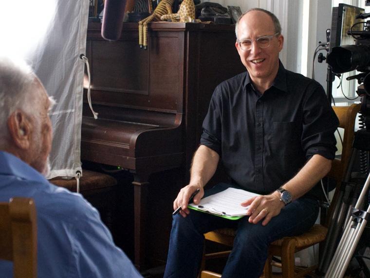 Peter Miller interviews a subject on camera