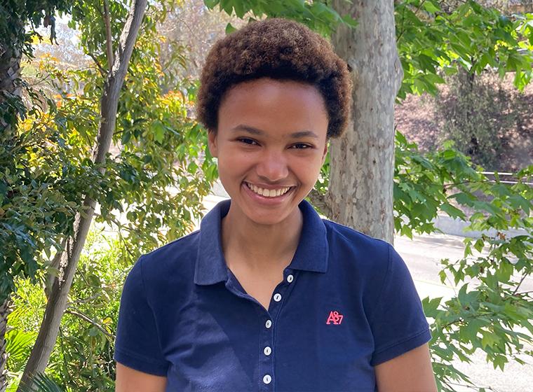 Student smiles outdoors