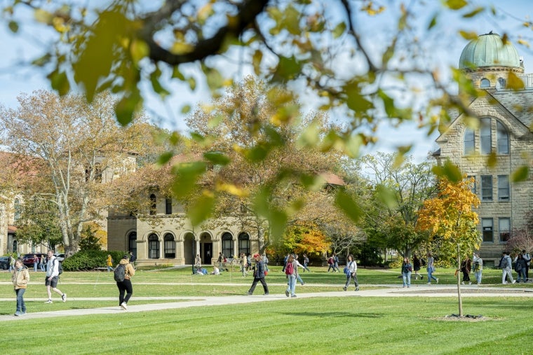 Fall trees with students walking in Wilder Bowl