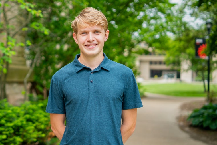 Student smiles on campus