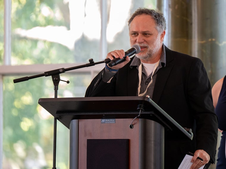 a person speaking into a microphone at an event
