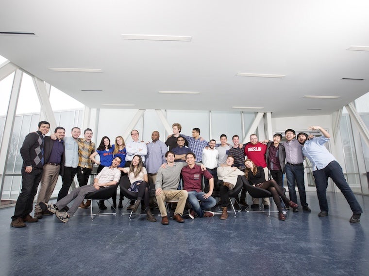 Group of students and alumni posing together indoors at the LaunchU program.