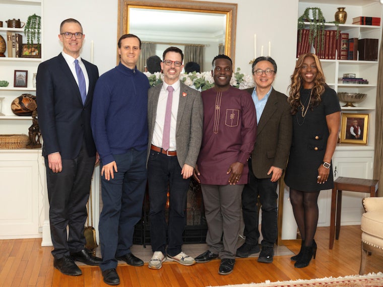 Six people posing for a photo in the President's home.