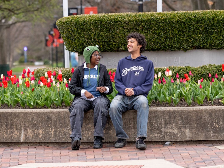 Two students sitting in Tappan Square