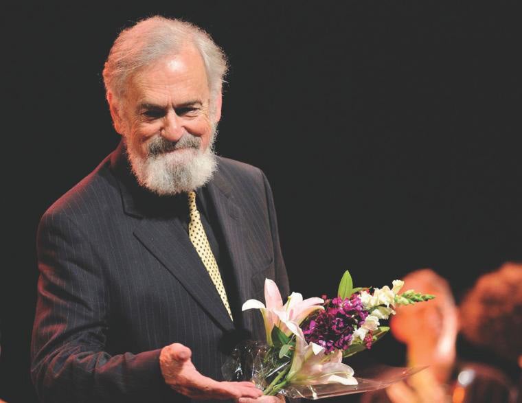 a photo of a professor receiving flowers after a performance