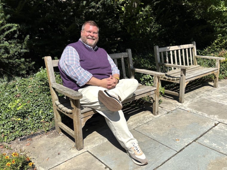 Chris Jorgenson seated on a park bench.