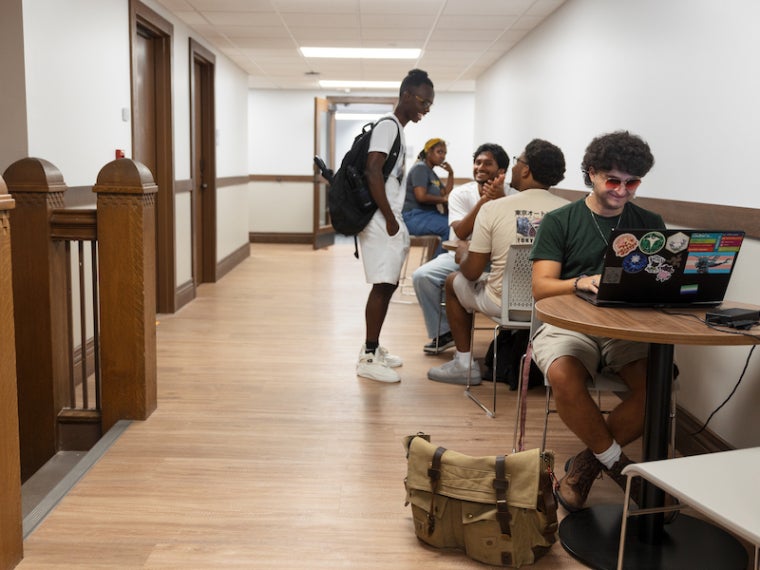 students studying and visiting in a Wilder Hall social space.
