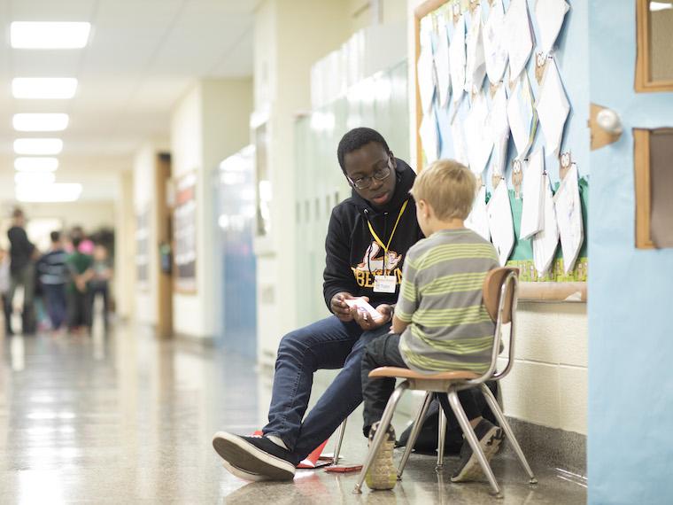 Photo of Oberlin student tutoring a student in the local elementary school.