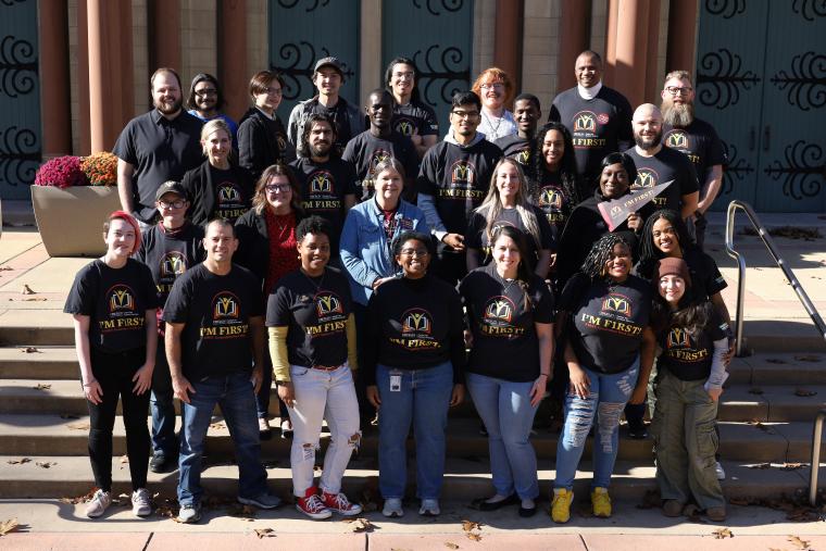 A group of first-generation students, staff and faculty on campus.