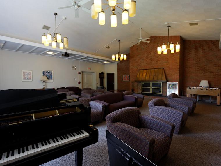 Inside of Kade House lounge with piano and couches