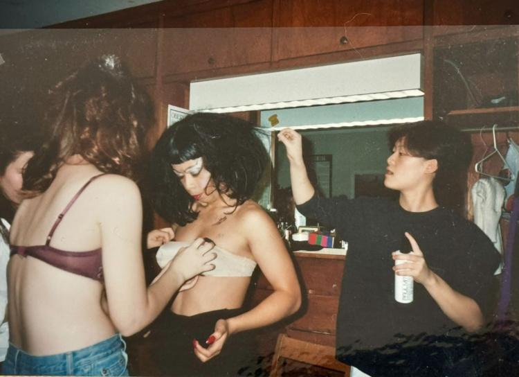 Three Oberlin Students are in a dorm room getting dressed for Drag Ball . 