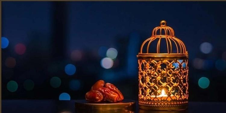 Gold lantern besides small bowl of dates