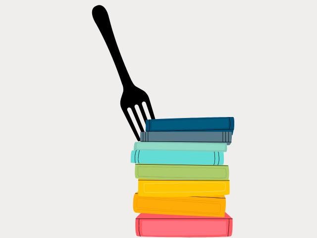 Fork stabbed into a colorful stack of books