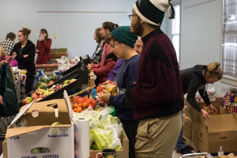 Members of the Bike Co-op and the Resource Conservation Team organize and distribute food