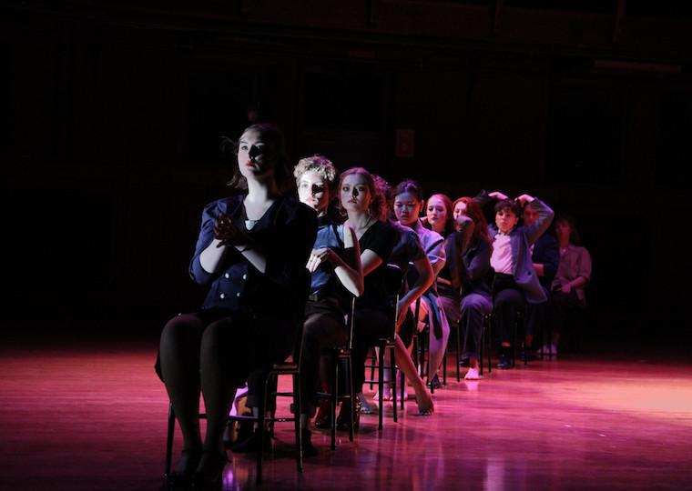 A row of seated students on a stage.