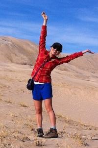 The author posing for a photo in a desert