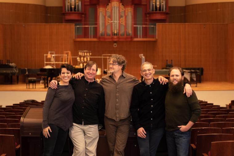 Five people standing in front of the stage in Warner Concert Hall; Elizabeth Ogonek, Stephen Hartke, Xak Bjerken, Timothy Weiss, and Jesse Jones.