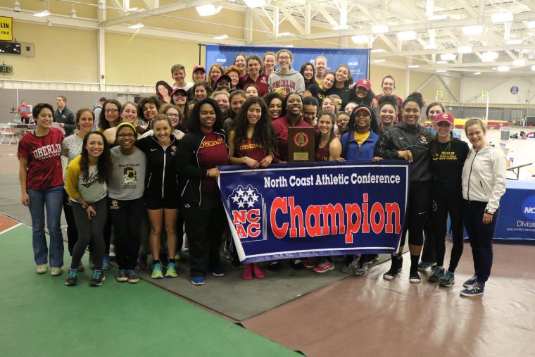 The team shows off their championship banner.