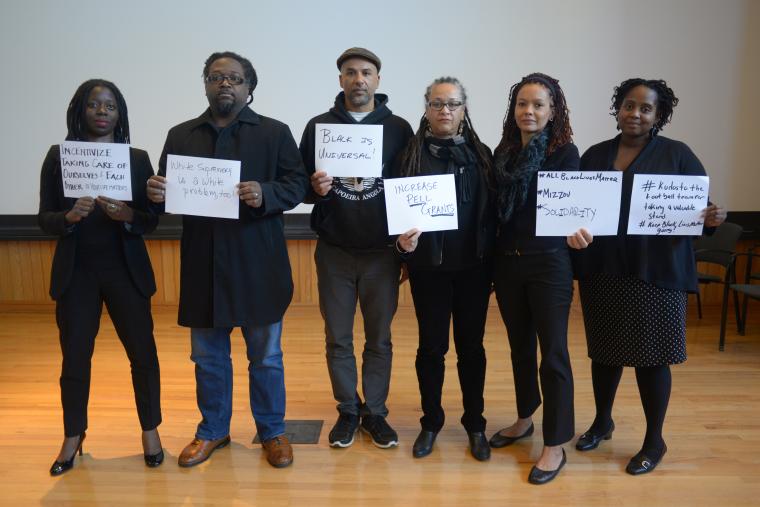 6 professors holding handwritten signs. Complete text follows.