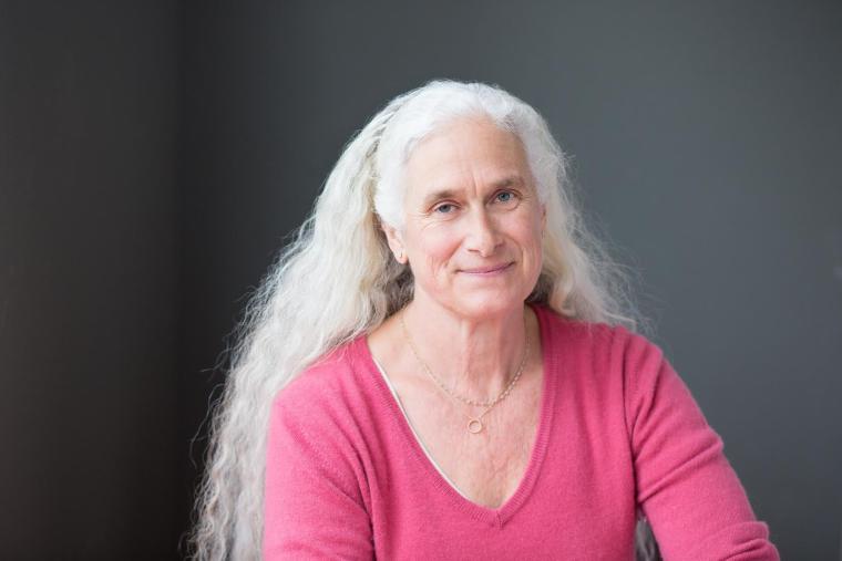woman posing for portrait with pinck shirt and long white hair