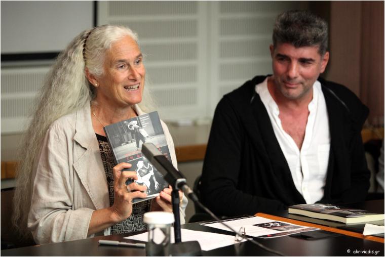 Ann Cooper Albright holds up her book