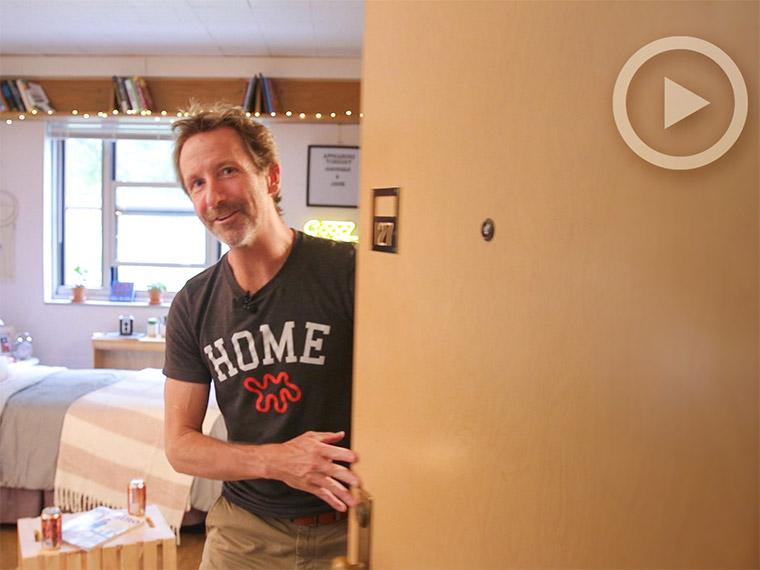 Man standing in dorm room doorway