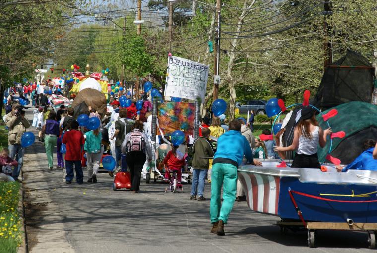 Parade participants march down the street.