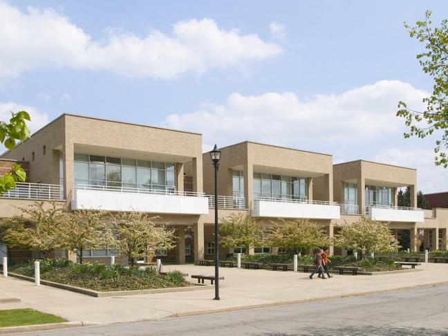 Two people walking in front of Stevenson Hall 