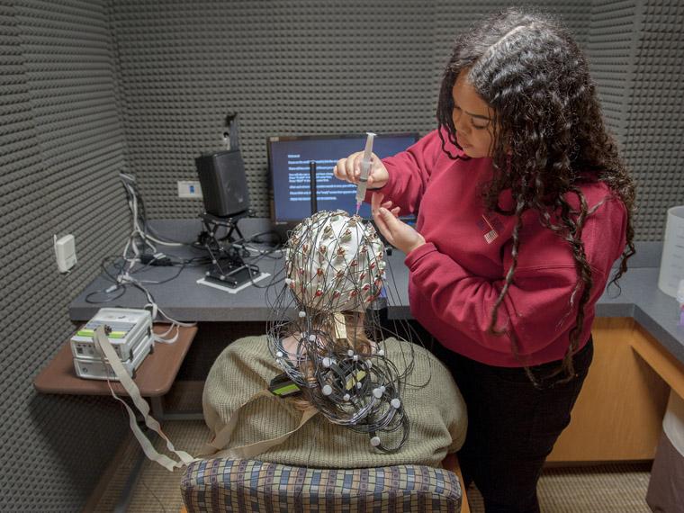 student uses EEG on another for research.