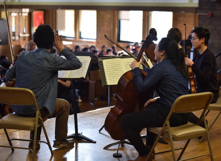 string ensemble musicians performing for children.