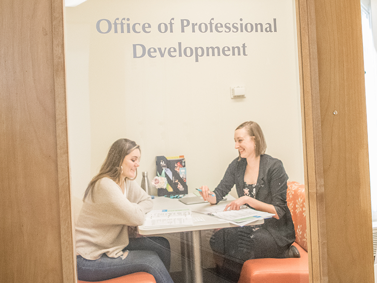 Dana Jessen works with a student on a grant