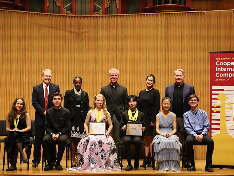 Gathering of Cooper Competition jury members, prizewinning violinists, and competition sponsors, on Warner Concert Hall stage.