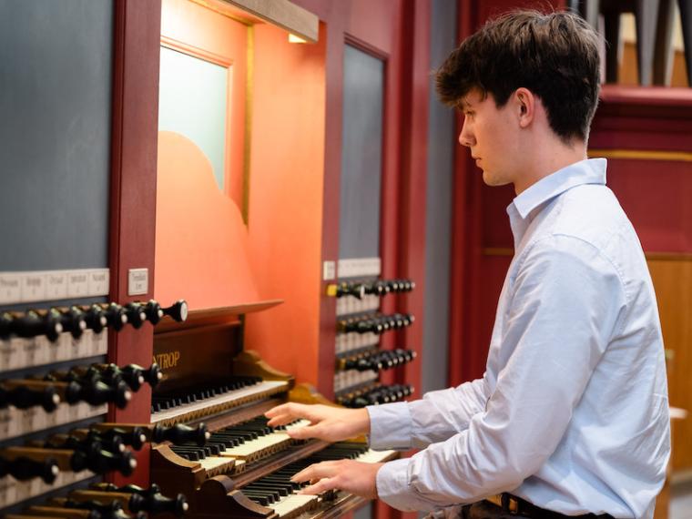 student Daniel Jacky playing the organ.