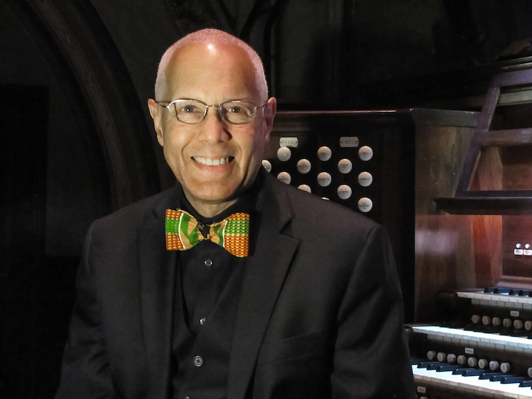 David Hurd sits in front of the organ