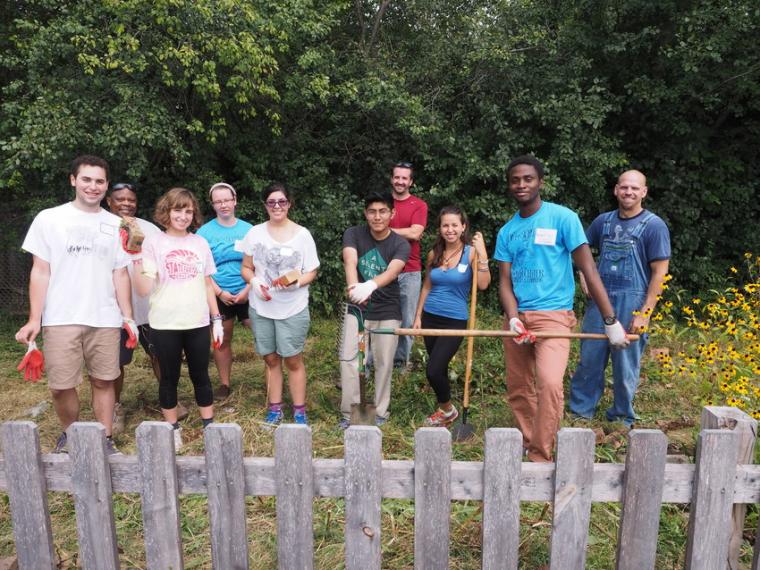 Day of Service volunteers remove bricks and invasive plant species at Prospect Elementary School