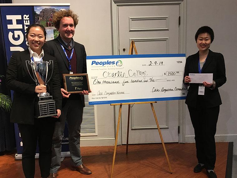students pose with first place trophy 