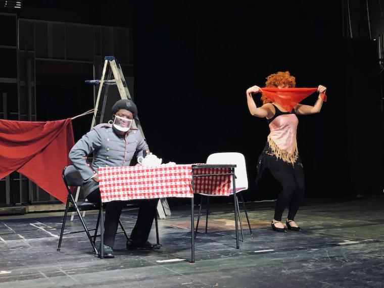 Two actors performing on a stage.