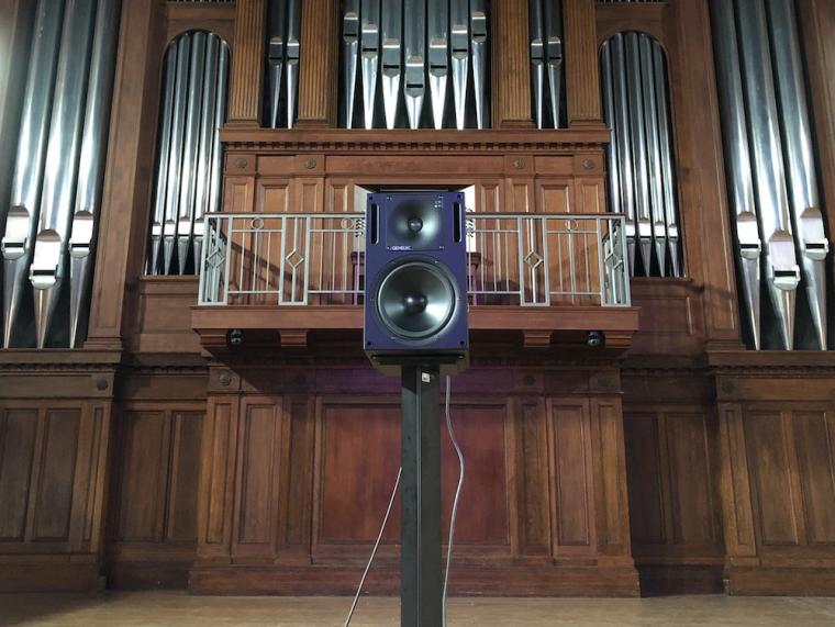 speaker mounted on the stage of Finney Chapel.