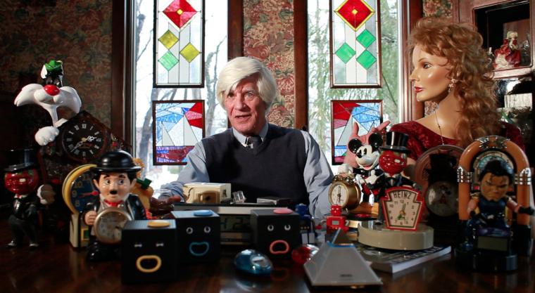 McKinly surronded by his collection of unusual clocks.