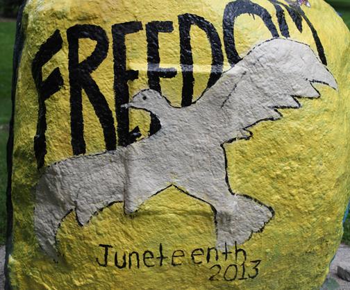 A rock painted with a dove and the words "Freedom Juneteenth 2013"
